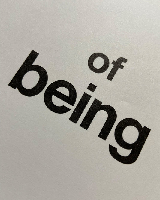 Detail eines Bleisatz Druckes mit den Worten ”of being“ in schwarzer Groteskschrift auf Papier